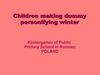 Children making dummy personifying winter.